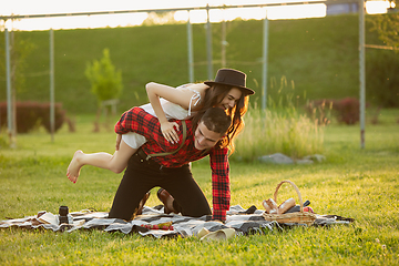 Image showing Caucasian young and happy couple enjoying a picnic in the park on summer day