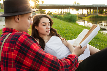 Image showing Caucasian young and happy couple enjoying a picnic in the park on summer day