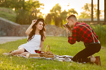 Image showing Caucasian young and happy couple enjoying a picnic in the park on summer day