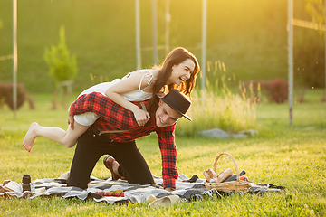 Image showing Caucasian young and happy couple enjoying a picnic in the park on summer day