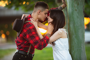 Image showing Caucasian young and happy couple enjoying a picnic in the park on summer day