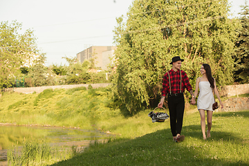 Image showing Caucasian young and happy couple enjoying a picnic in the park on summer day