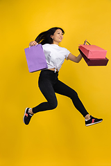 Image showing Portrait of young asian woman isolated on yellow studio background