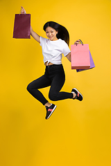 Image showing Portrait of young asian woman isolated on yellow studio background