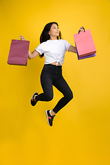 Image showing Portrait of young asian woman isolated on yellow studio background