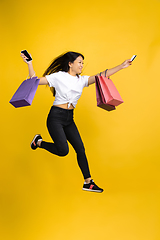 Image showing Portrait of young asian woman isolated on yellow studio background