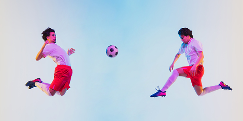 Image showing Football or soccer player on gradient background in neon light - motion, action, activity concept