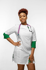 Image showing Beautiful african-american doctor or nurse smiling isolated over white studio background