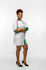 Image showing Beautiful african-american doctor or nurse smiling isolated over white studio background