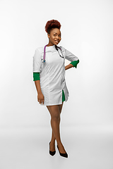 Image showing Beautiful african-american doctor or nurse smiling isolated over white studio background