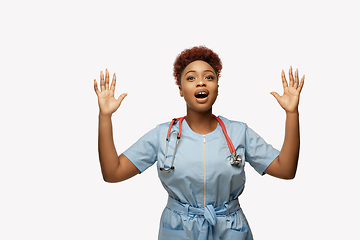 Image showing Beautiful african-american doctor or nurse smiling isolated over white studio background