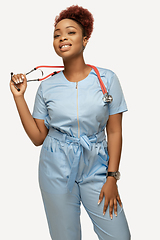 Image showing Beautiful african-american doctor or nurse smiling isolated over white studio background