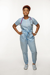 Image showing Beautiful african-american doctor or nurse smiling isolated over white studio background