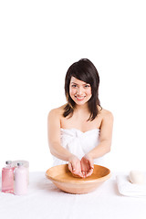 Image showing Beautiful asian girl washing face