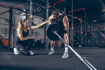 Image showing Beautiful young sporty couple training, workout in gym together