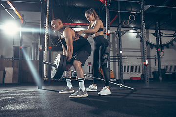 Image showing Beautiful young sporty couple training, workout in gym together