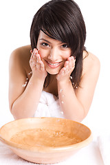 Image showing Beautiful asian girl washing face