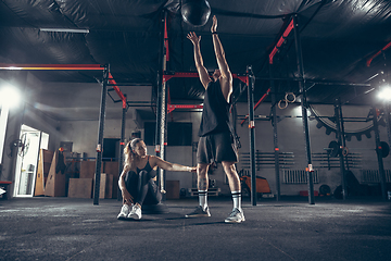 Image showing Beautiful young sporty couple training, workout in gym together