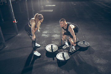 Image showing Beautiful young sporty couple training, workout in gym together