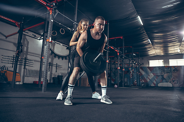 Image showing Beautiful young sporty couple training, workout in gym together