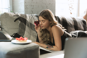 Image showing Portrait of pretty young girl in modern apartment in the morning. Resting, calm, salisfied. Youth and wellness concept.