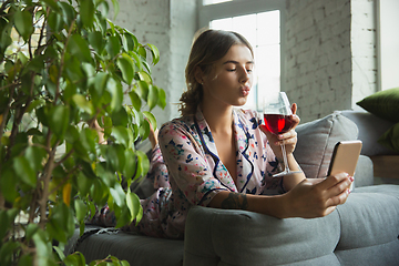 Image showing Portrait of pretty young girl in modern apartment in the morning. Resting, calm, salisfied. Youth and wellness concept.