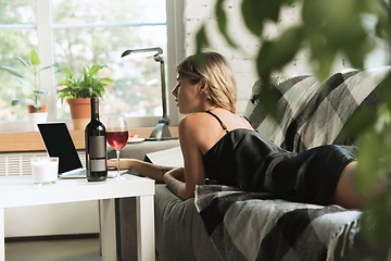 Image showing Portrait of pretty young girl in modern apartment in the morning. Resting, calm, salisfied. Youth and wellness concept.