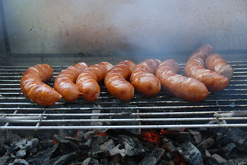 Image showing Sausages cooking on the grill