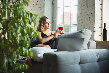 Image showing Portrait of pretty young girl in modern apartment in the morning. Resting, calm, salisfied. Youth and wellness concept.