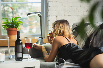 Image showing Portrait of pretty young girl in modern apartment in the morning. Resting, calm, salisfied. Youth and wellness concept.