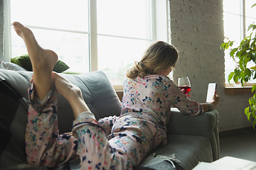 Image showing Portrait of pretty young girl in modern apartment in the morning. Resting, calm, salisfied. Youth and wellness concept.