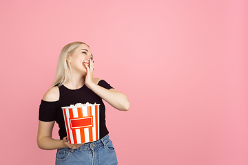 Image showing Portrait of young caucasian woman with bright emotions on coral pink studio background