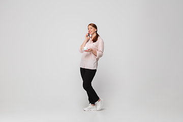 Image showing Young caucasian woman in casual wear. Bodypositive female character, plus size businesswoman