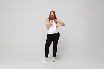 Image showing Young caucasian woman in casual wear. Bodypositive female character, plus size businesswoman