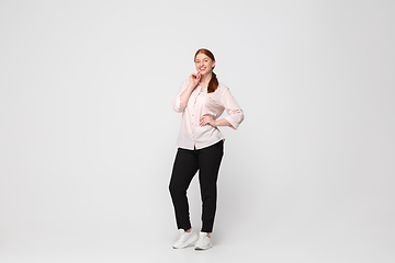 Image showing Young caucasian woman in casual wear. Bodypositive female character, plus size businesswoman