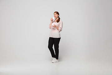 Image showing Young caucasian woman in casual wear. Bodypositive female character, plus size businesswoman