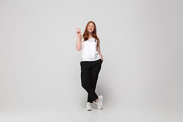 Image showing Young caucasian woman in casual wear. Bodypositive female character, plus size businesswoman