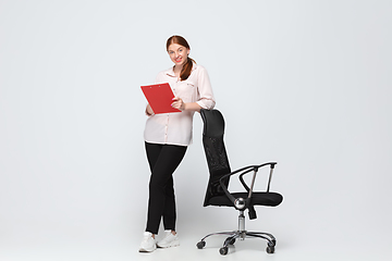 Image showing Young caucasian woman in casual wear. Bodypositive female character, plus size businesswoman