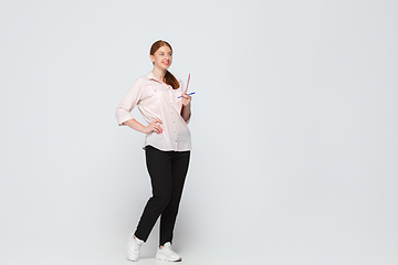 Image showing Young caucasian woman in casual wear. Bodypositive female character, plus size businesswoman