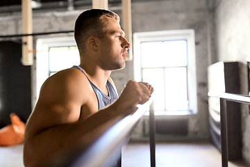 Image showing young man at parallel bars in gym