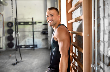 Image showing happy smiling young man in gym