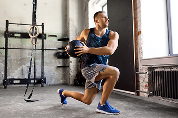 Image showing young man exercising with medicine ball in gym