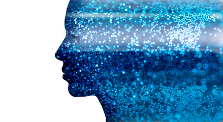 Image showing silhouette of woman face on blue glitters