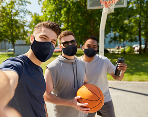 Image showing happy men taking selfie on basketball playground