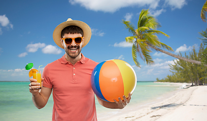 Image showing happy man with orange juice and beach ball