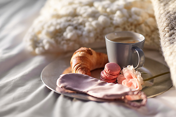 Image showing croissant, coffee and eye sleeping mask in bed