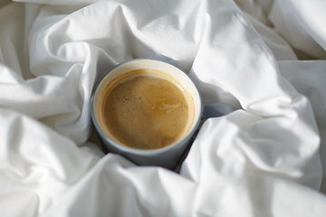 Image showing cup of coffee in bed