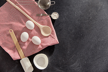 Image showing eggs, flour, spoon, spatula, strainer and towel