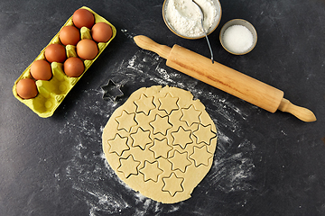 Image showing dough, rolling pin, eggs, flour and sugar on table