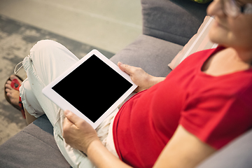 Image showing Mature woman spending time being quarantined - caucasian woman using modern gadgets, drinking tea